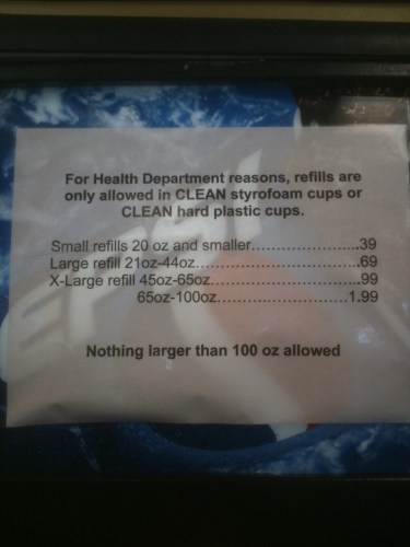 Photo of a sign listing the prices for refilling various sizes of cups with fountain pop at a gas station