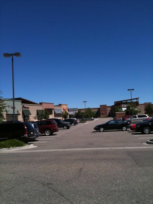 Terrible parking job by car in parking lot